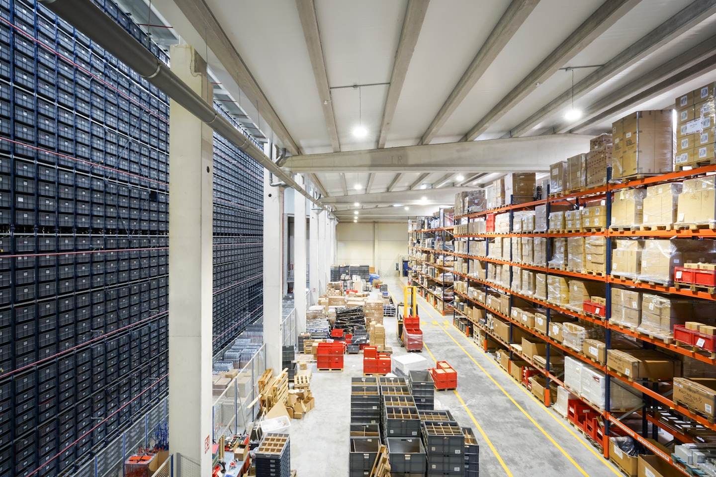 A vast industrial warehouse with shelves of containers and boxes.